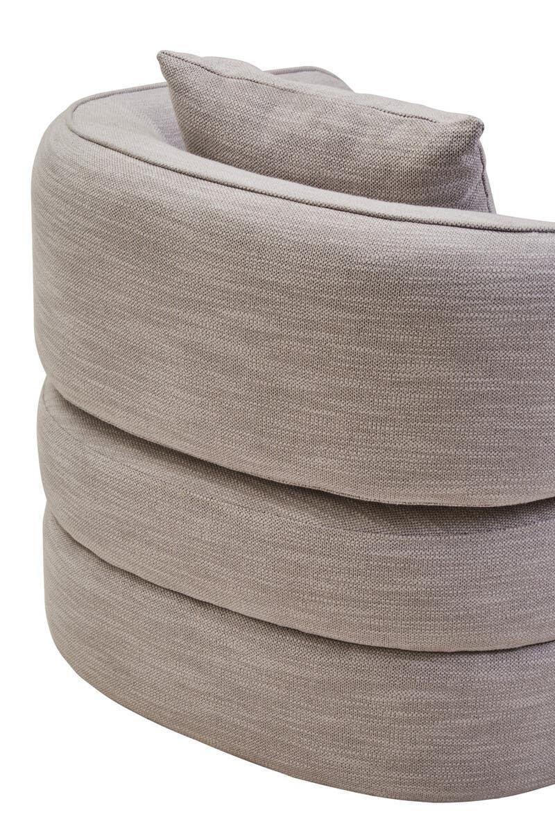 Curved beige fabric sofa backrest with layered upholstery and matching cushion detail