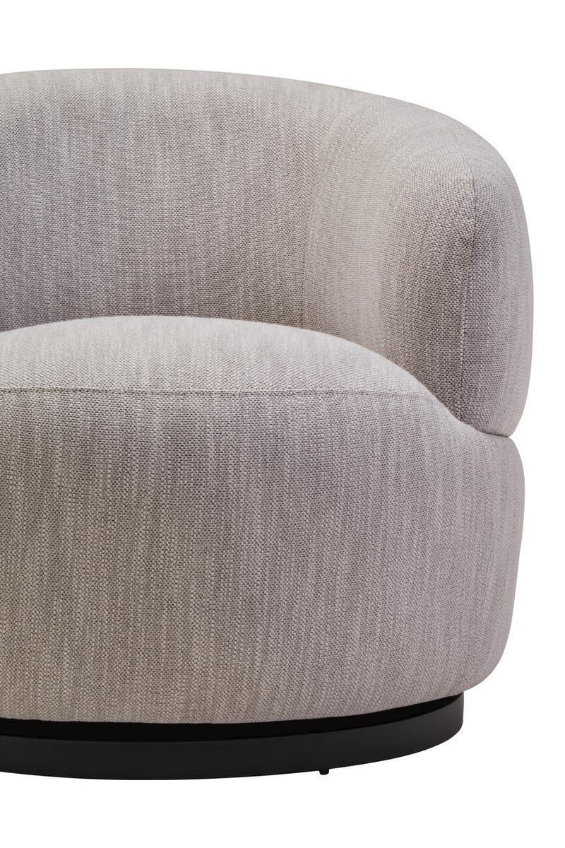 Closeup of grey fabric armchair with curved backrest and black circular base