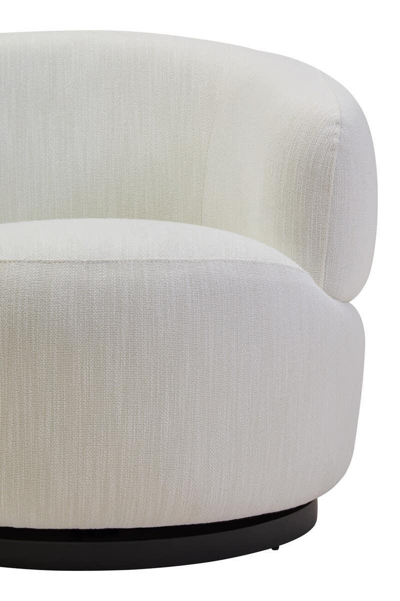 Cream fabric swivel chair with curved backrest and black circular base close-up
