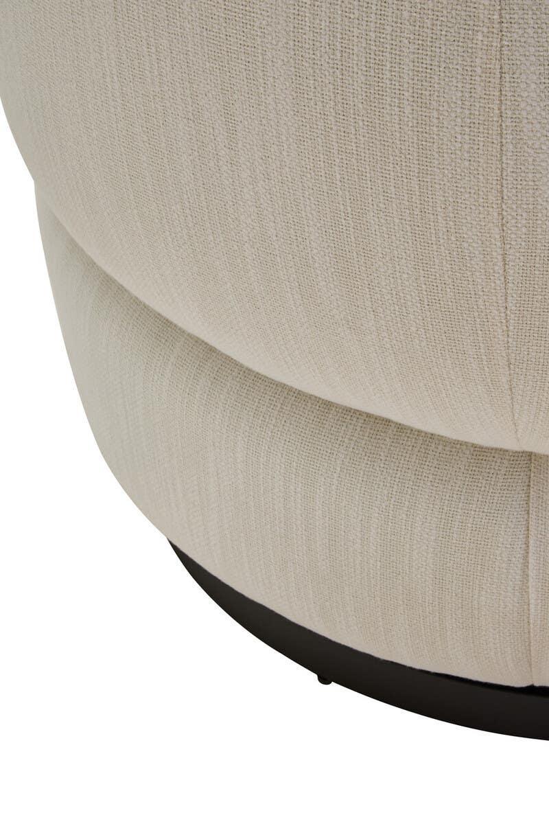 Close view of cream fabric armchair base with textured upholstery and black swivel stand