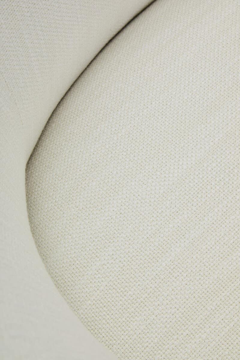 Close-up of cream fabric sofa cushion with textured upholstery