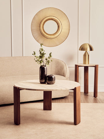 Round coffee table featuring a natural travertine marble top supported by sturdy acacia wood legs.