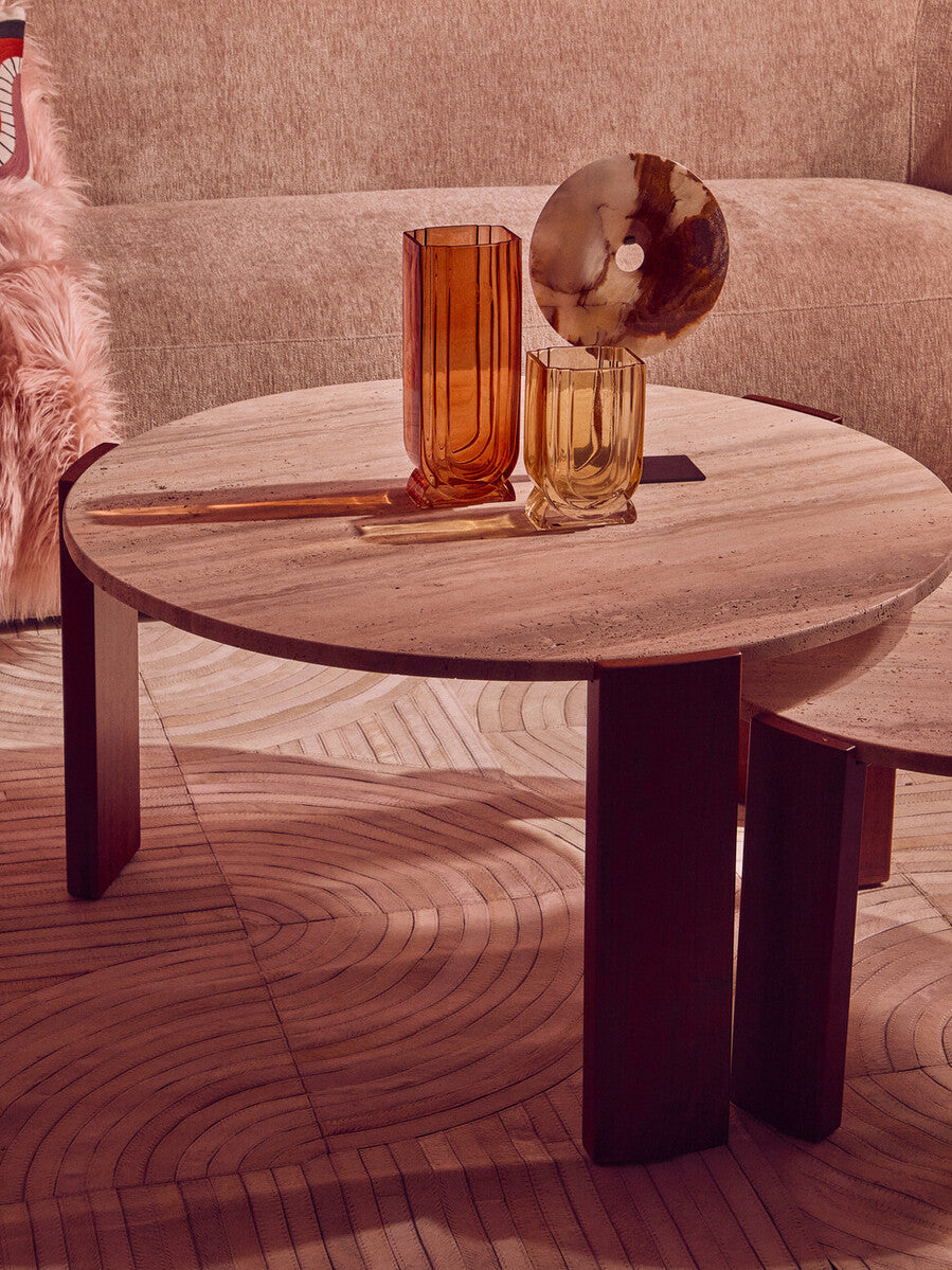 Round coffee table featuring a natural travertine marble top with a smooth finish, supported by sturdy acacia wood legs.