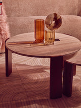Round coffee table featuring a natural travertine marble top with a smooth finish, supported by sturdy acacia wood legs.