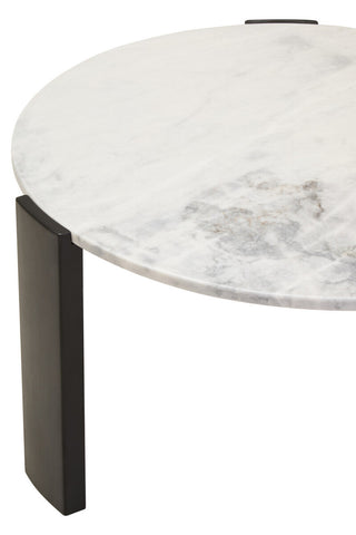 Round coffee table featuring a smooth white marble top with subtle gray veining, supported by sleek black acacia wood legs.