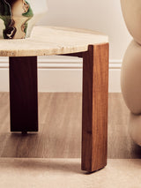 Round coffee table featuring a cream travertine marble top with a smooth finish, supported by sturdy acacia wood legs that have a rich, warm tone.