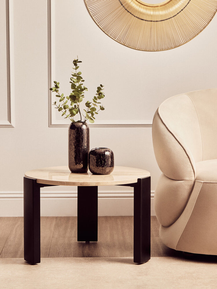 Round cream marble top coffee table with a sleek design, featuring a smooth surface and contrasting black legs.