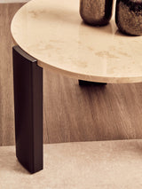 Round cream marble top coffee table featuring a smooth surface with subtle veining, supported by sleek black acacia wood legs.