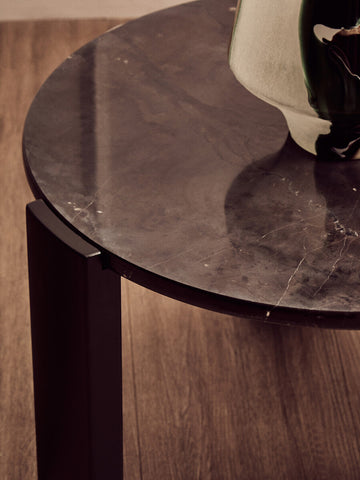 Round black marble top coffee table featuring a sleek design with a smooth surface and subtle veining, supported by sturdy acacia wood legs.