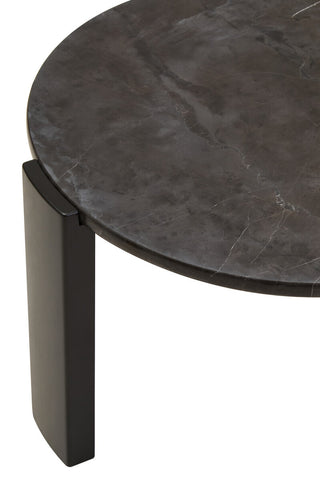 Round black marble top coffee table featuring a sleek, polished surface with subtle veining. The sturdy acacia wood legs provide a modern contrast, enhancing its elegant design.