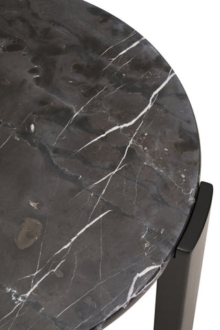 Round black marble tabletop featuring striking white veining, complemented by sleek black acacia wood legs.