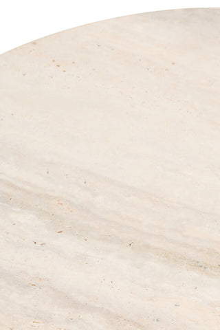 Round side table featuring a smooth travertine top with subtle beige and cream veining. The surface displays natural textures and small pockmarks typical of travertine stone.