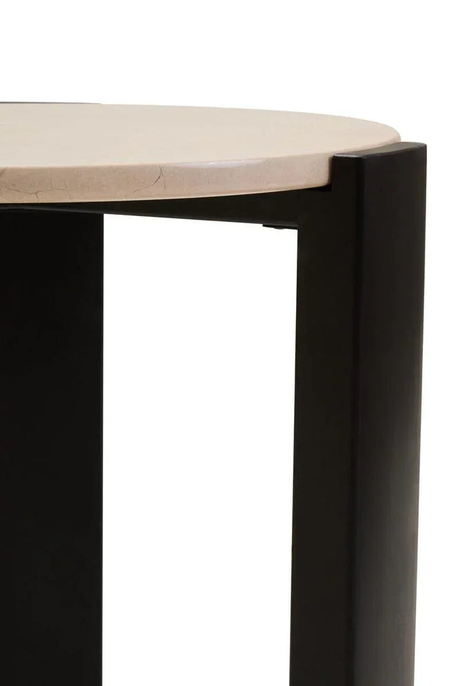 Closeup of round marble table top with black metal legs, modern furniture detail