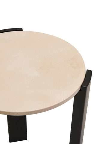 Round side table featuring a smooth cream marble top with subtle veining, supported by sleek black acacia wood legs.