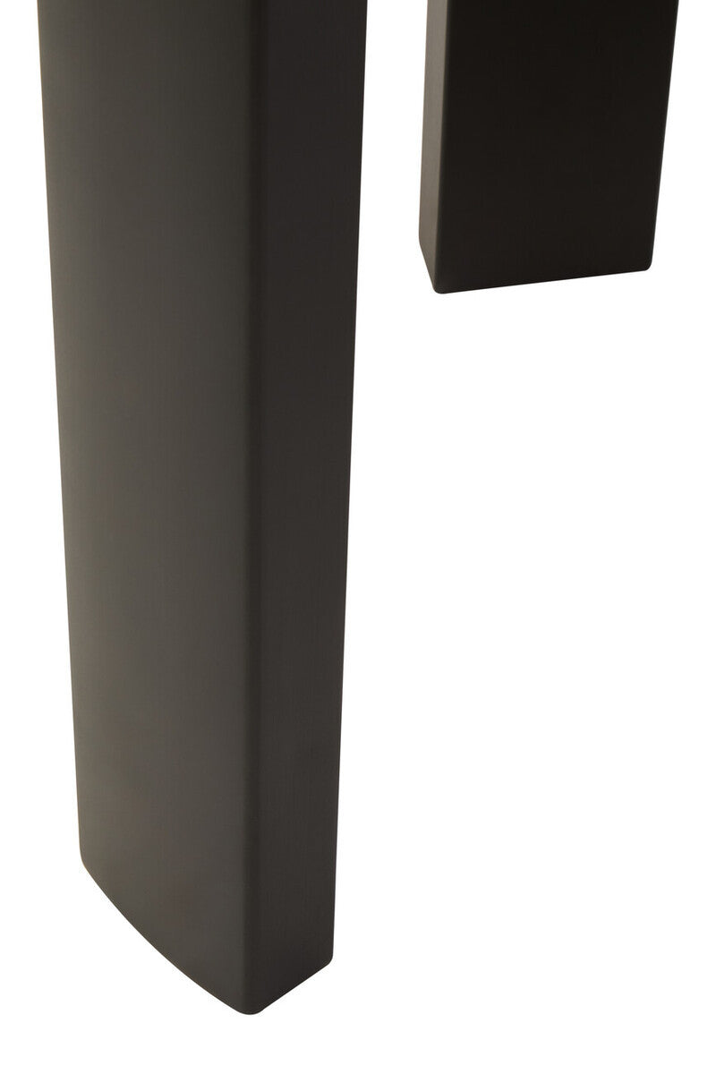 Close-up view of a black acacia wood leg of a round side table, showcasing its smooth finish and slightly rounded edges.