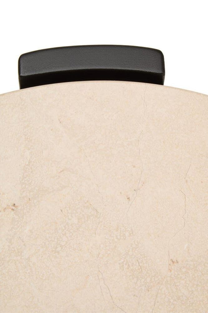 Marble side table top with black metal edge detail, close-up view