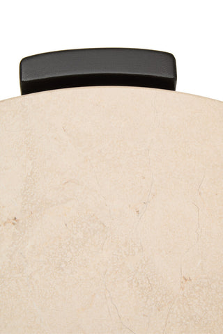 Round side table featuring a cream marble top with subtle veining and a sleek black handle.