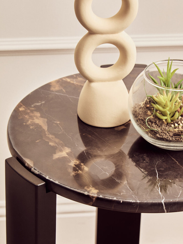 Round side table featuring a luxurious black marble top with gold veining, complemented by sleek black acacia wood legs.