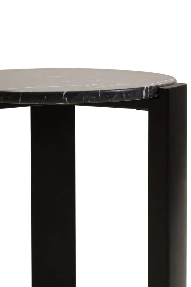 Round black marble coffee table close-up showing top and sturdy leg design