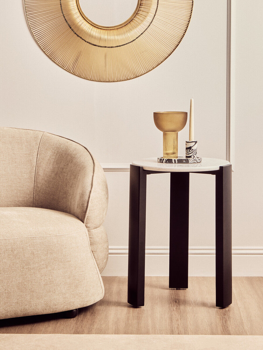 Round side table featuring a sleek white marble top and sturdy black acacia wood legs.