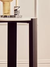 Round side table featuring a sleek white marble top and sturdy black acacia wood legs.