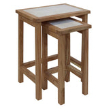 Oak nest of tables with white stone tops, two tables stacked neatly