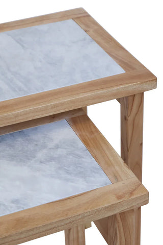 Stacked wooden nest tables with marble tops, close detail of surfaces and corners