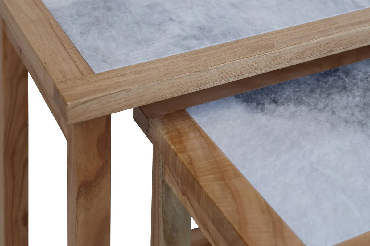 Set of two wooden nesting tables with marble effect tops, close-up corner view