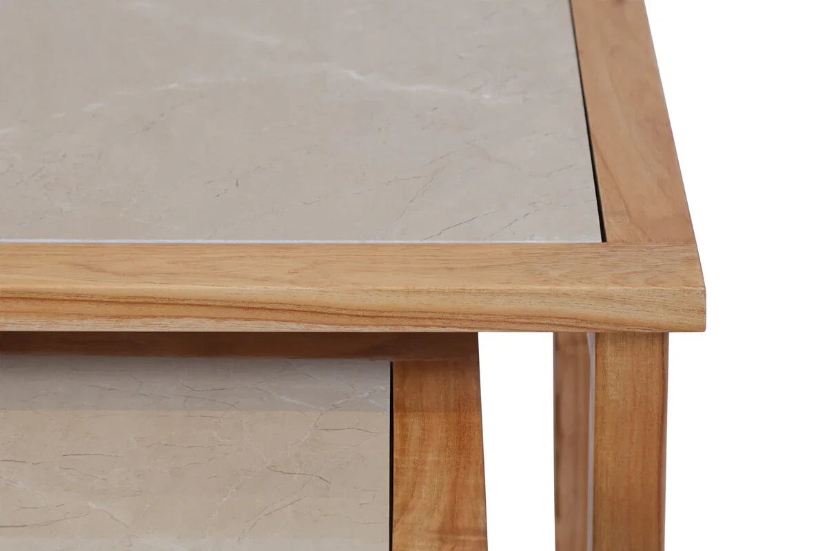 Closeup of wooden dining table with beige marble top and corner detail