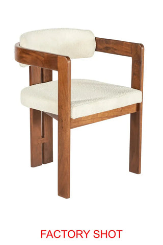 Wooden dining chair with cream upholstered seat and curved backrest on white background