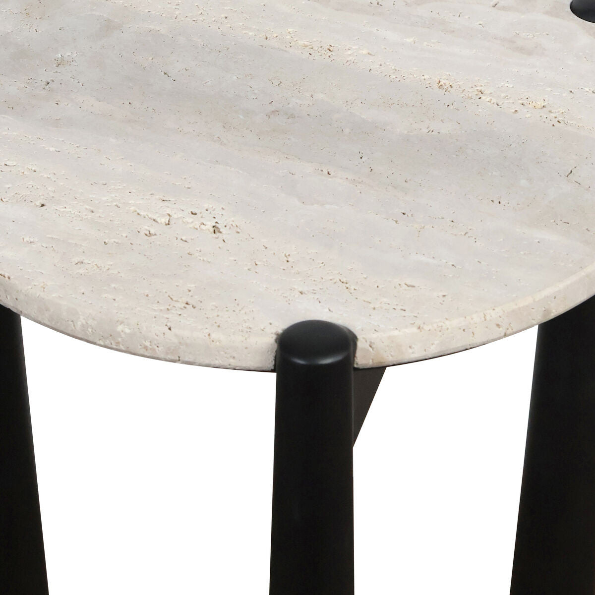Round travertine top with a textured surface, supported by sleek black mango wood legs.