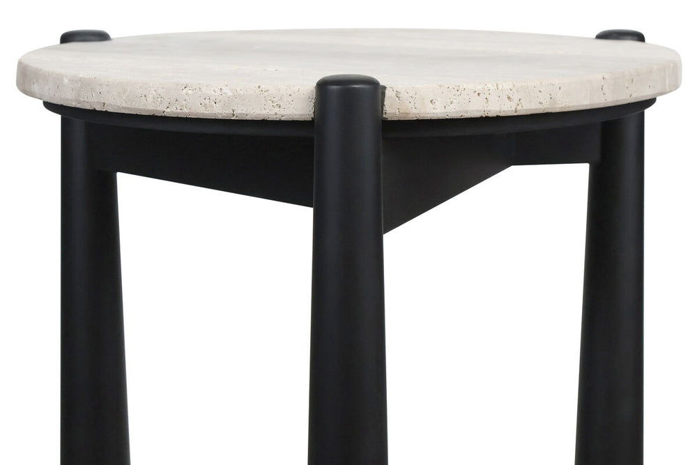 Round travertine top side table featuring a smooth, natural stone surface with subtle texture, supported by sleek black mango wood legs.