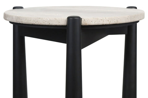 Round travertine top side table featuring a smooth, natural stone surface with subtle texture, supported by sleek black mango wood legs.