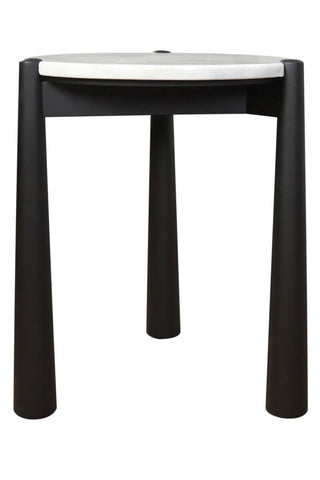 Round side table featuring a sleek white marble top and a sturdy black mango wood base. The table stands on four cylindrical legs, providing a modern aesthetic.