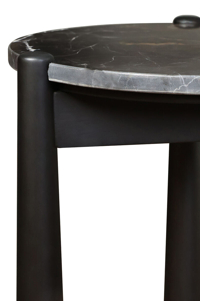 Round black and white marble top side table featuring smooth, rounded edges and a sleek black mango wood base.