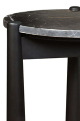 Round black and white marble top side table featuring smooth, rounded edges and a sleek black mango wood base.