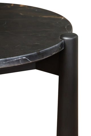 Round side table featuring a sleek black and white marble top with subtle veining, complemented by sturdy mango wood legs.