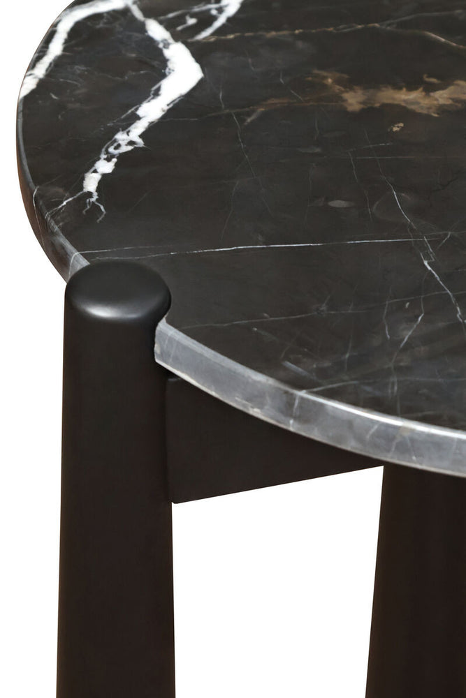 Black and white marble top side table featuring a smooth, rounded edge and striking veining patterns, supported by sturdy mango wood legs with a sleek black finish.