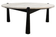 Round coffee table featuring a natural travertine top with a textured surface, supported by sleek, tapered black mango wood legs.
