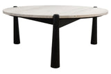Round coffee table featuring a natural travertine top with a textured surface, supported by sleek, tapered black mango wood legs.