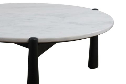 Round coffee table featuring a smooth white marble top with subtle gray veining, supported by sleek black mango wood legs.