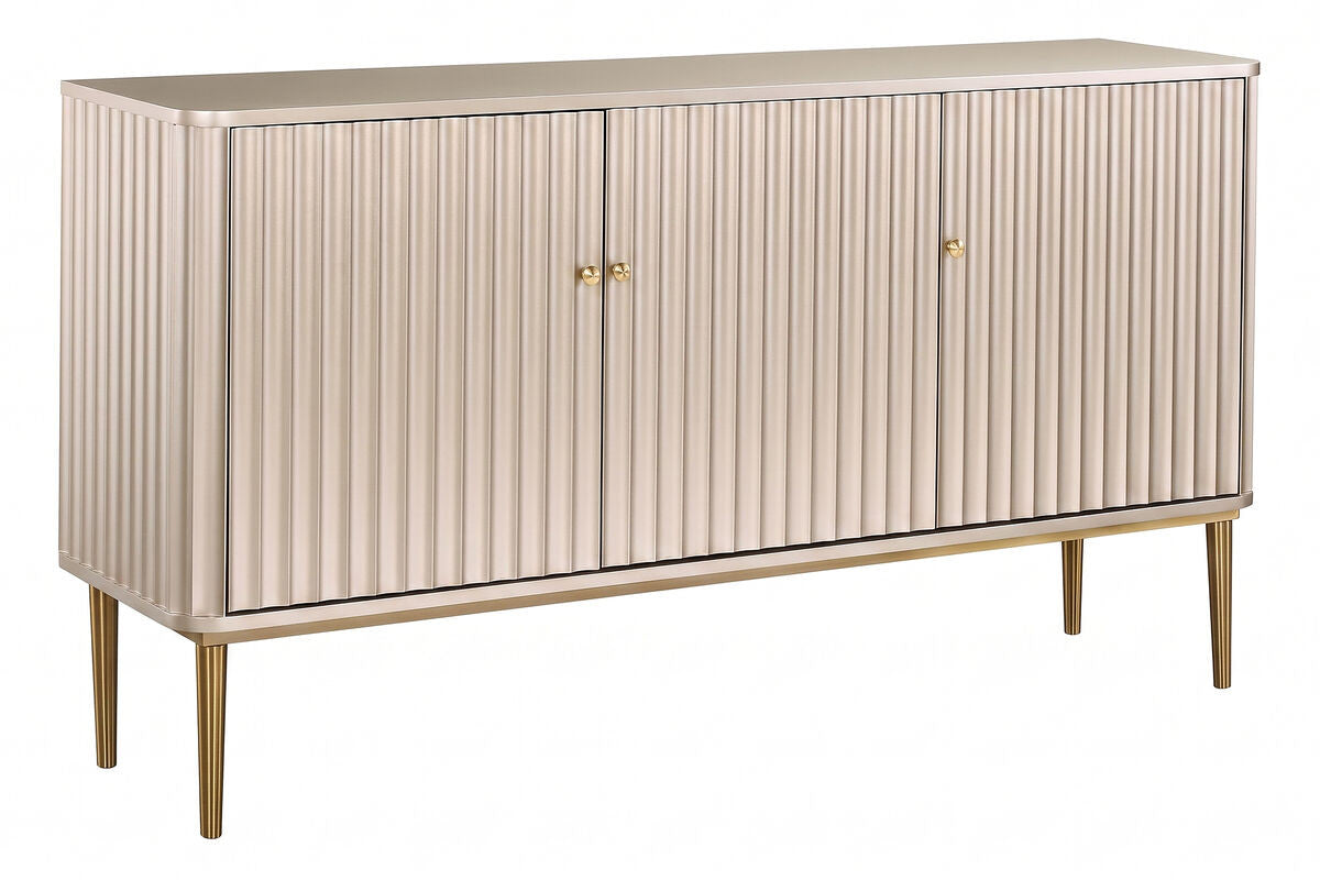 Elegant sideboard featuring three doors with a distinctive flute detail, finished in a soft gold hue. The piece is supported by slender, tapered legs in a matching gold tone.