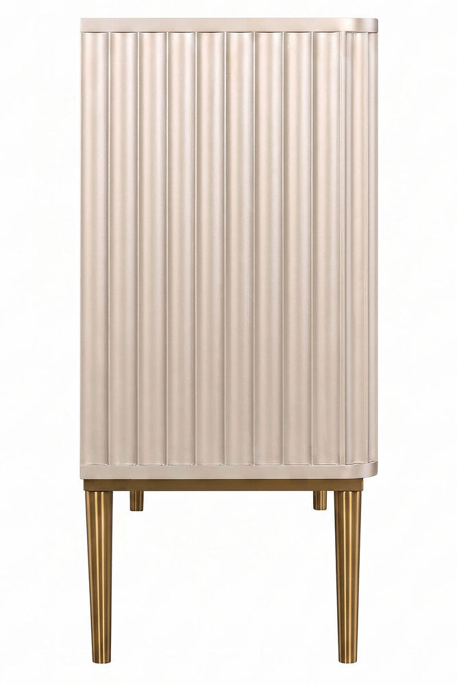 Three-door sideboard featuring a sleek, ribbed design in a soft gold finish. The cabinet is supported by elegant, tapered legs, also in gold, adding a touch of sophistication.
