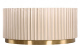 Round coffee table featuring a textured, fluted design in a soft beige color, complemented by a sleek gold stainless steel base.