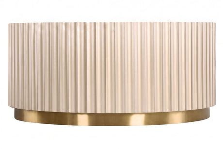 Round coffee table featuring a textured, fluted design in a soft beige color, complemented by a sleek gold stainless steel base.