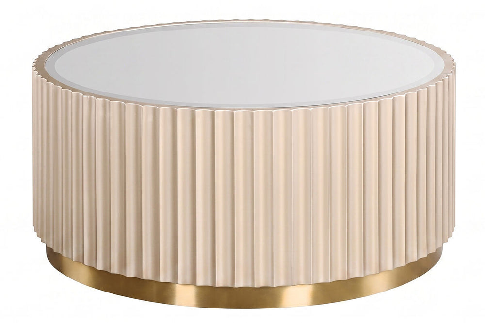 Round coffee table featuring a fluted design in a soft beige color, complemented by a sleek mirrored top. The base is adorned with a shiny gold trim, adding a touch of elegance.
