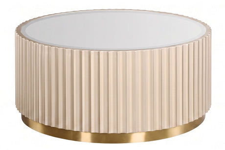 Round coffee table featuring a fluted design in a soft beige color, complemented by a sleek mirrored top. The base is adorned with a shiny gold trim, adding a touch of elegance.