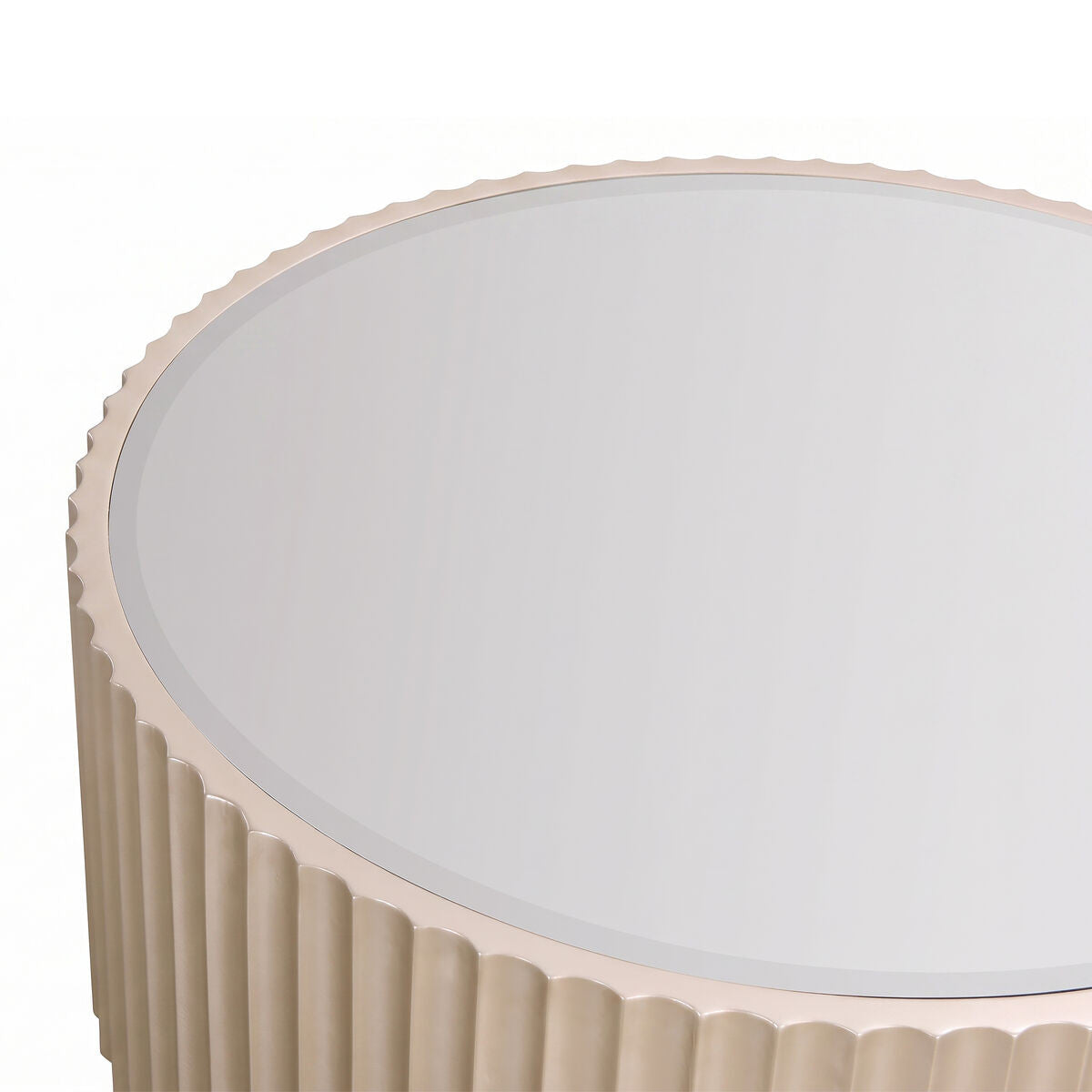Round coffee table featuring a mirrored top and a fluted gold base. The edges of the table have a scalloped design, adding a touch of elegance.