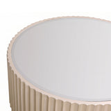 Round coffee table featuring a mirrored top and a fluted gold base. The edges of the table have a scalloped design, adding a touch of elegance.