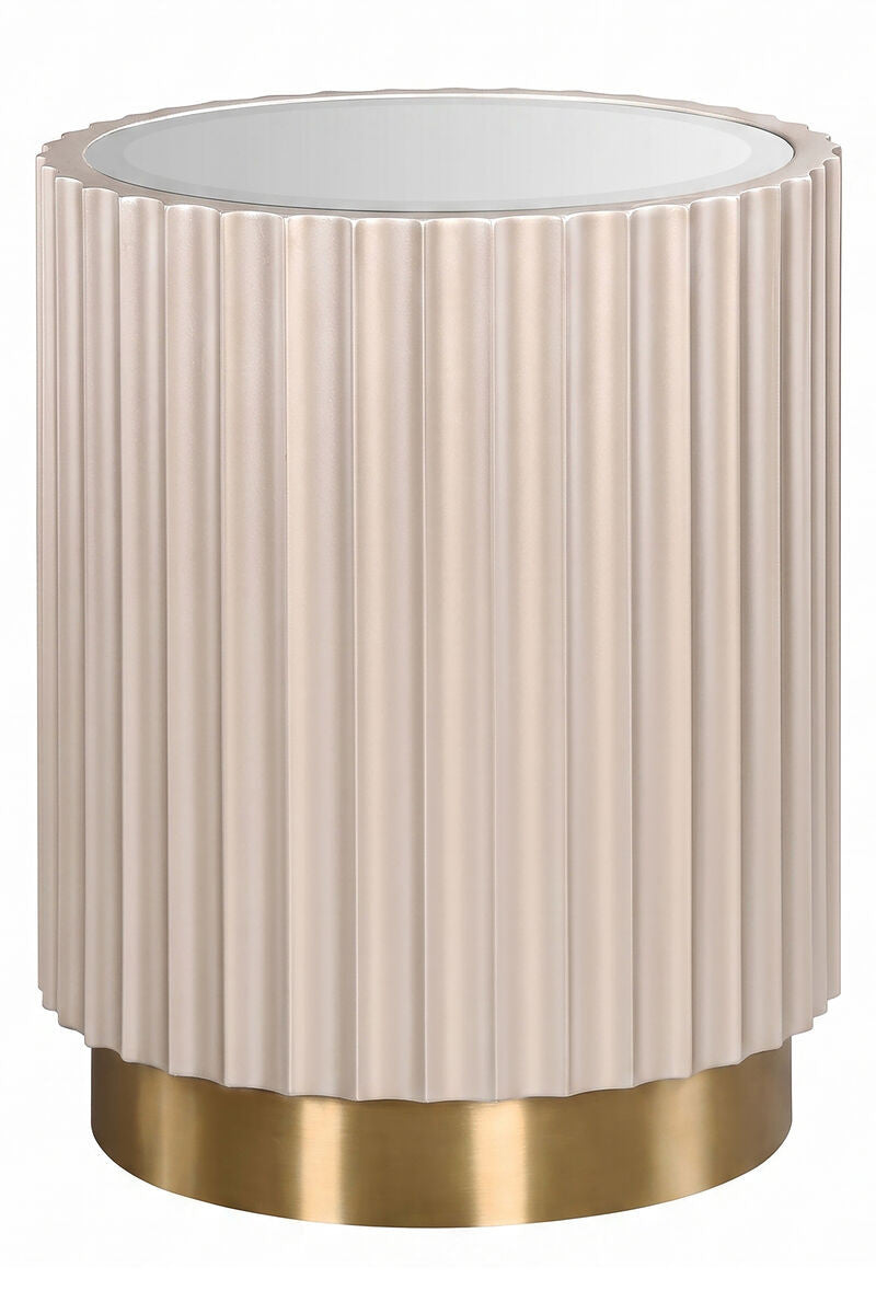 Round side table featuring a glass top and a fluted design in a soft beige color, complemented by a sleek gold base.